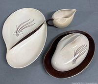 Divided dish, butter dish with lid and gravy boat arranged on floor showing design and condition.