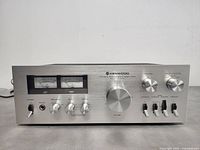 Front view showing VU meters, power and headphone jacks, tone controls and main volume knob.