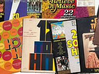 Seven LP sleeves fanned out showing cover art and partial titles