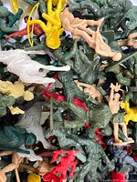 pile of assorted plastic toy soldiers and figurines