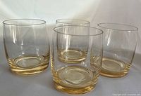 Front angled view of all four gold-toned tumblers showing shape and color