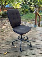 Full view of chair showing seat, backrest, and caster base