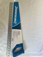 Full saw in sleeve beside ruler showing 20-inch length