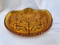 Top view showing entire amber pressed glass dish and pattern