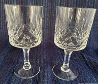 Front view of the two matching cut crystal wine glasses