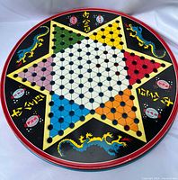 Chinese checkers side of round tin showing star board and dragon graphics