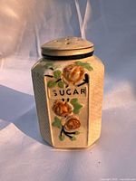 Front view of sugar shaker showing hand-painted design and "SUGAR" label