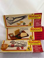 Three boxed Westmark kitchen tools stacked