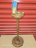 Full view of oak pedestal smoking stand with brass ashtray and accessories