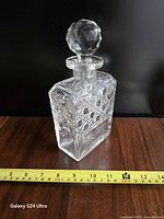 Decanter upright with stopper and tape measure for height