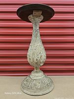 Front view of carved wood pedestal showing full height and detailing