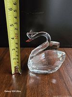 Crystal swan beside tape measure showing approx 3 in height