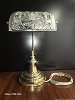 Front view of brass banker lamp with crystal shade and cord