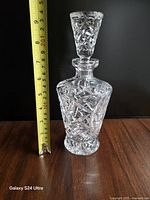 Front view of decanter beside measuring tape showing height