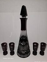 Full view of decanter with stopper and four shot glasses