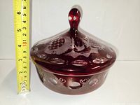 Side view of bowl with lid showing height tape measure about 13 cm