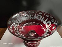 Top view showing cut-to-clear grapevine pattern inside ruby red bowl