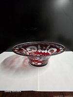 Oblique view of ruby red cut-to-clear dish showing pattern and flared form