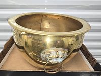 Front view showing brass planter and foo-dog handle