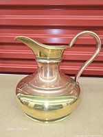 left profile of copper and brass pitcher