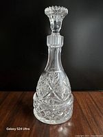 Front view of cut crystal decanter with stopper showing pattern detail