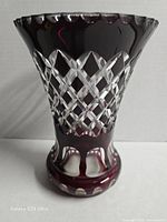 Front view showing flared form, lattice cuts, ruby overlay