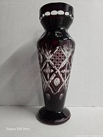 Full view front of ruby red cut to clear vase