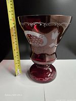 Full view of vase beside tape measure indicating height around 8.75 in