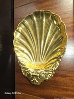 Front view of gold-glazed scallop shell porcelain dish