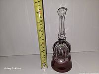 Bell standing beside metric ruler showing height