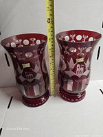 Pair of Egermann ruby red cut to clear vases with measuring tape