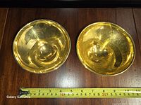 Top view showing both gold glazed bowls and measuring tape for diameter reference