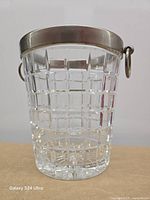 Front view of cut crystal champagne bucket showing lattice pattern and metal rim with handles