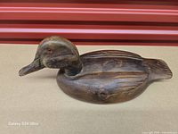 Left side view of carved wooden duck decoy