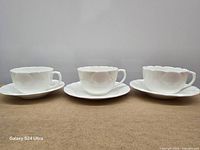 Front view of three cups on saucers/plate