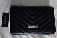 Front view showing chevron quilting, gold bebe logo, attached tag