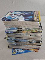 Tall stack of trading cards side view
