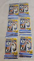 Front view of six sealed Panini Donruss basketball card packs