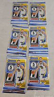 Six sealed Donruss basketball card packs on tabletop