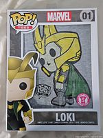 Front of boxed Funko Pop! Tees Marvel Loki T-shirt showing Loki graphic and size small sticker