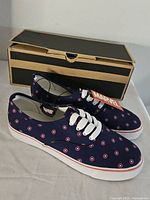 Side view of both sneakers with box