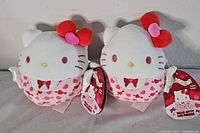 Front view of both Hello Kitty Squishmallows showing design details and tags