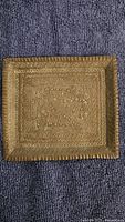Front view of rectangular brass tray showing etched pattern and rim details