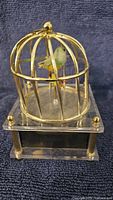 Overall view bird cage music box on acrylic base