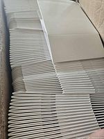 Stack of flat white pastry boxes inside shipping carton