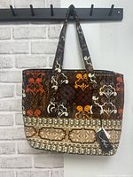 Front view of A Marie quilted tote showing pattern, straps and hang tag