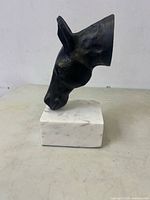 Left profile of cast iron horse head on marble base