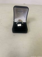 Ring in presentation box, gemstone and metal visible
