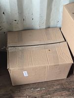 Sealed cardboard shipping box on floor