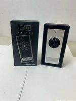 Front view of MUAMA Enence translator beside retail box